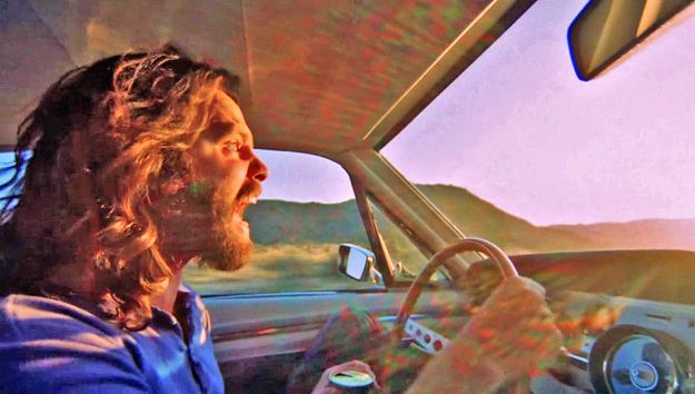 Karl-Ludwig Poggemann - dazzled maniac Jim Morrison drowns out the haunting whimper of a coyote dying on the road by his dreadful death-scream into the abyssal sun - Flickr - La Déviation